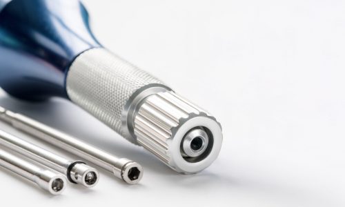 closeup-implant-surgical-kits-mini-screw-screw-driver-drilling-bits-white-background