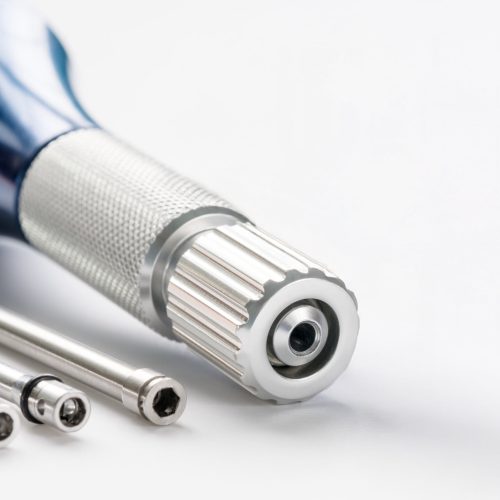 closeup-implant-surgical-kits-mini-screw-screw-driver-drilling-bits-white-background